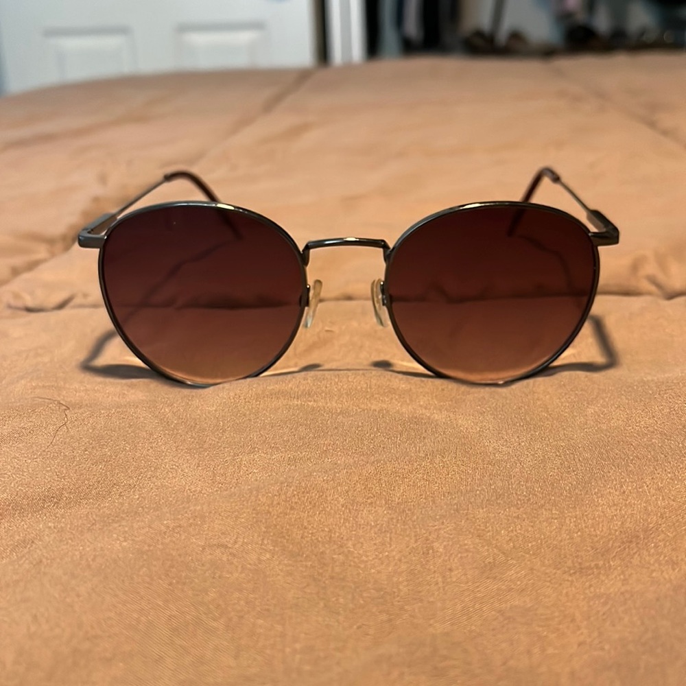 Dark sunglasses. Some slight scratches.